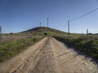 windmills rise above a hill in this rural area of the pacific area of california