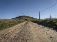 windmills rise above a hill in this rural area of the pacific area of california