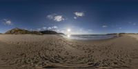 a 3d beach scene with blue sky, ocean and sand ripplers below clouds, and the sun setting on a rocky shore