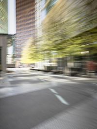 a man with a black shirt riding a green motorcycle in the city street through a blurry picture