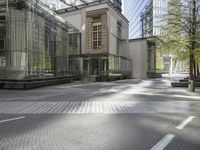 a paved city street with several buildings on both sides and a skylight on the side