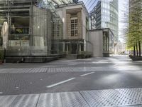 a paved city street with several buildings on both sides and a skylight on the side