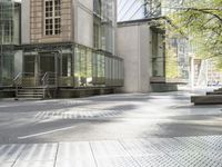 a paved city street with several buildings on both sides and a skylight on the side