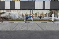 the street has electric car charging spaces in the front of it on the ground next to the parking meters