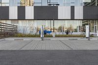 the street has electric car charging spaces in the front of it on the ground next to the parking meters