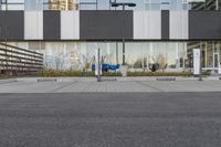 the street has electric car charging spaces in the front of it on the ground next to the parking meters