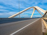 a bridge that is across from another bridge and has some lines going down it and there is no clouds on the sky