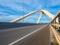 a bridge that is across from another bridge and has some lines going down it and there is no clouds on the sky