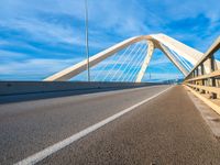 a bridge that is across from another bridge and has some lines going down it and there is no clouds on the sky