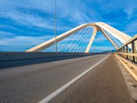 a bridge that is across from another bridge and has some lines going down it and there is no clouds on the sky