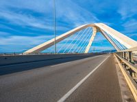 a bridge that is across from another bridge and has some lines going down it and there is no clouds on the sky