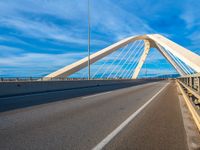 a bridge that is across from another bridge and has some lines going down it and there is no clouds on the sky