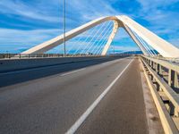 a bridge that is across from another bridge and has some lines going down it and there is no clouds on the sky