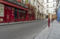 two people on a street with no cars on it in front of a bar with a sign that says private rue de france