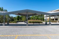 parking lot with empty parking spaces under a canopy over a street area at a city