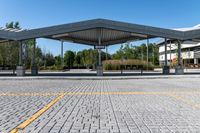 parking lot with empty parking spaces under a canopy over a street area at a city