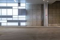 an empty parking garage with a few lights on the side of the building, with no people in