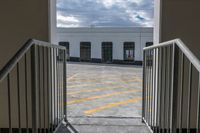 a gate with the doorway open showing a building and a cloudy sky in the background