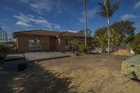 a house that has been partially under construction with some trees on the other side of the driveway