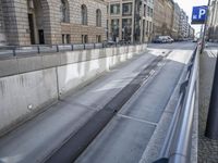 the sidewalk is very empty with the road behind it, which looks very quiet and inviting