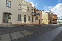 this is a side street with several buildings and a sign for the bus station that says'beware - to - get here '