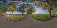 two fisheye photos show a quiet road through a field in the foreground is a field with trees and grassy area