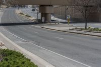 a single road with no traffic on it under an overpass overpass overpass