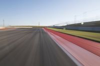 a picture of a race track with cars passing by on it as the driver speeds on