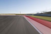 a picture of a race track with cars passing by on it as the driver speeds on