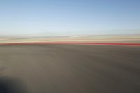 view of a car moving in a fast pace across the tarmac of a track