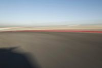 view of a car moving in a fast pace across the tarmac of a track