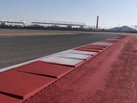a racing track with many ramps in it and cars around them and a sky background
