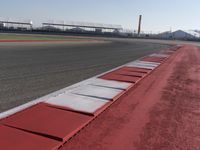 a racing track with many ramps in it and cars around them and a sky background