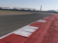 a racing track with many ramps in it and cars around them and a sky background