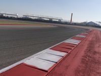 a racing track with many ramps in it and cars around them and a sky background