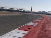 a racing track with many ramps in it and cars around them and a sky background
