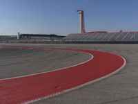 there is a small race track with red line painted on it with an area of yellow and red color