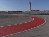 there is a small race track with red line painted on it with an area of yellow and red color