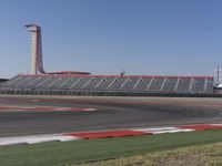 an empty track at a motorsports club with some red and white stripeing on it