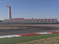 an empty track at a motorsports club with some red and white stripeing on it