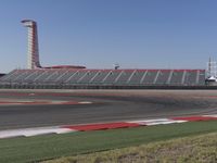 an empty track at a motorsports club with some red and white stripeing on it