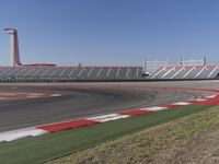 an empty track at a motorsports club with some red and white stripeing on it