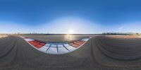 an oval view looking down the side of a track with a line of red and blue tires