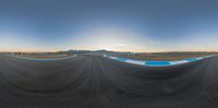 some large curved lines in the middle of a dirt field on a sunny day at an airport