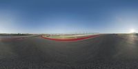 a wide view of a racetrack from a fisheye lens for a sports camera lens