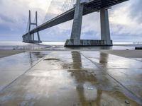 the bridge is standing in the rain as it rains over the ground with graffiti on the floor