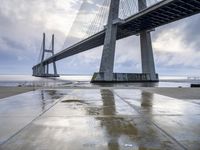 the bridge is standing in the rain as it rains over the ground with graffiti on the floor