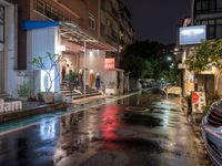 rain on the street in an urban setting at night time with neon signs that read, no parking