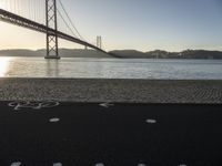 a bicycle lane on a paved beach below the golden gate bridge in san francisco, california