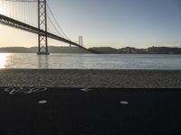 a bicycle lane on a paved beach below the golden gate bridge in san francisco, california